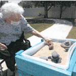 elderly woman wearing mask and Balancing Rocks at sharmar village